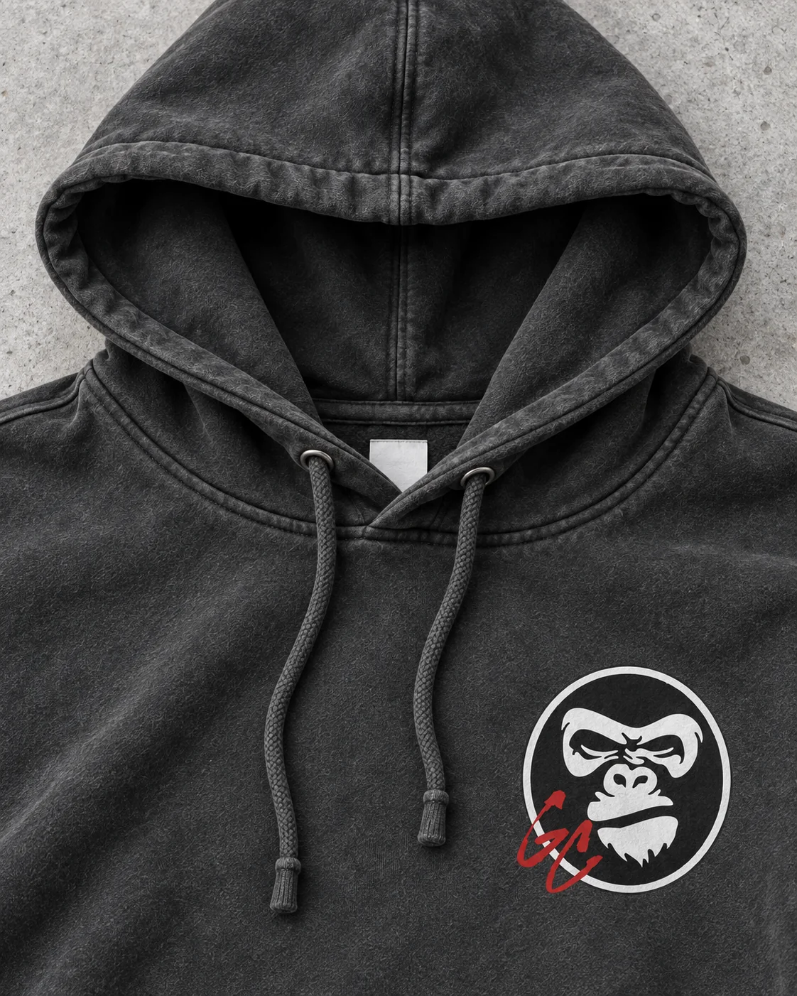 Close-up of the hood, drawcords and chest mark on the charcoal hoodie